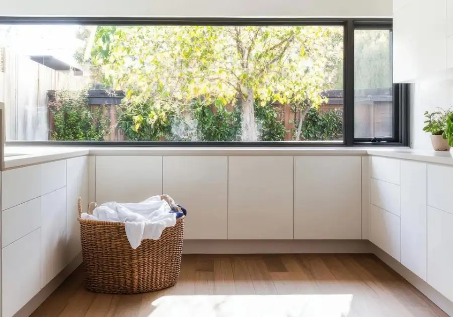 Bright laundry room with a washer and dryer beside a window